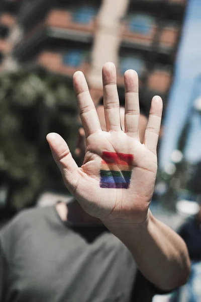 Person med regnbågsflagg i hans eller hennes hand — Stockfoto