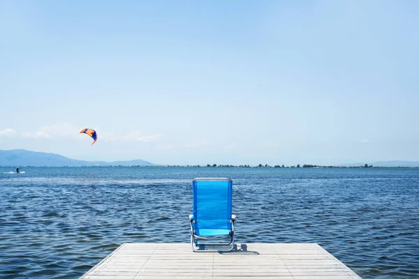 Lonely blue deck chair on a pier — Stock Photo, Image