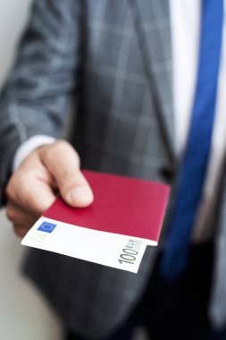 businessman with 100 euros in his passpor clipart