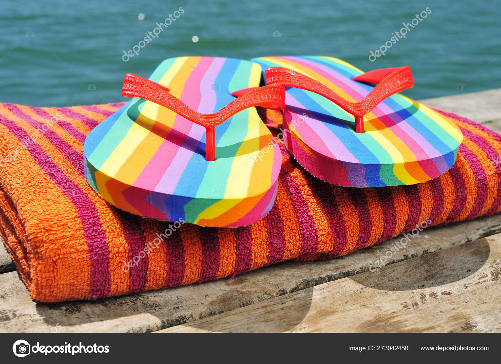 Rainbow flipflops and towel on a dock Stock Photo by ©nito103 273042480