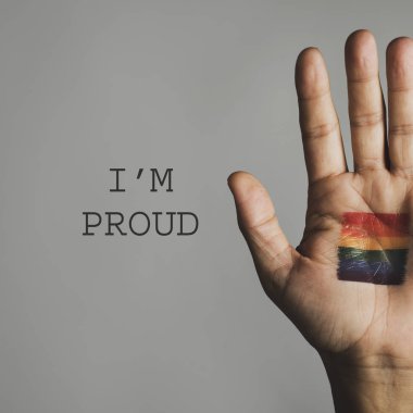 hand with a rainbow flag and text I am proud clipart