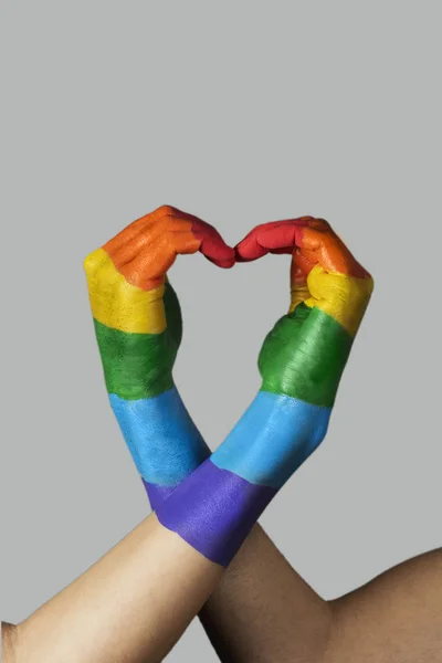 Hands forming a rainbow heart — Stock Photo, Image