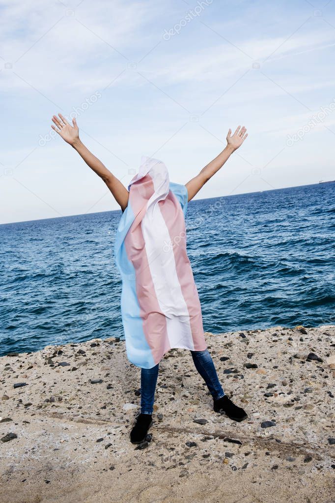 person covered with a transgender pride flag