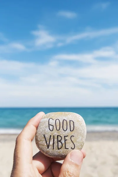 Text good vibes in a stone on the beach — Stock Photo, Image