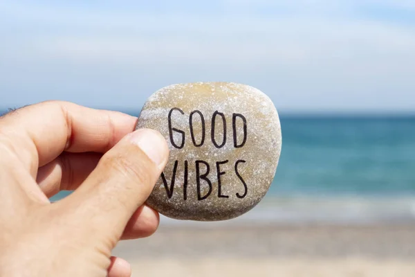 Text good vibes in a stone on the beach — Stock Photo, Image