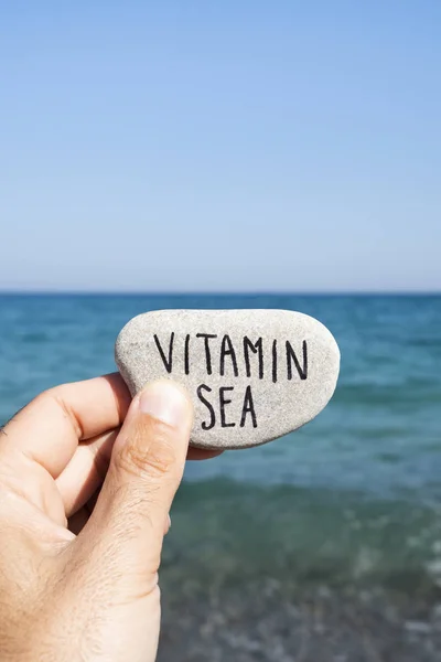 Text vitamin sea in a stone on the beach — Stock Photo, Image