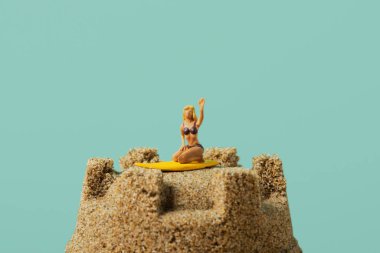 miniature woman on a sandcastle clipart