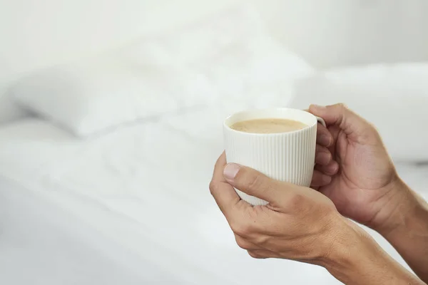 Man having a coffee in a bedroom — Stock Photo, Image