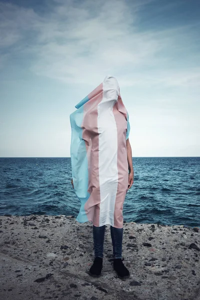 Person covered with a transgender pride flag — Stock Photo, Image