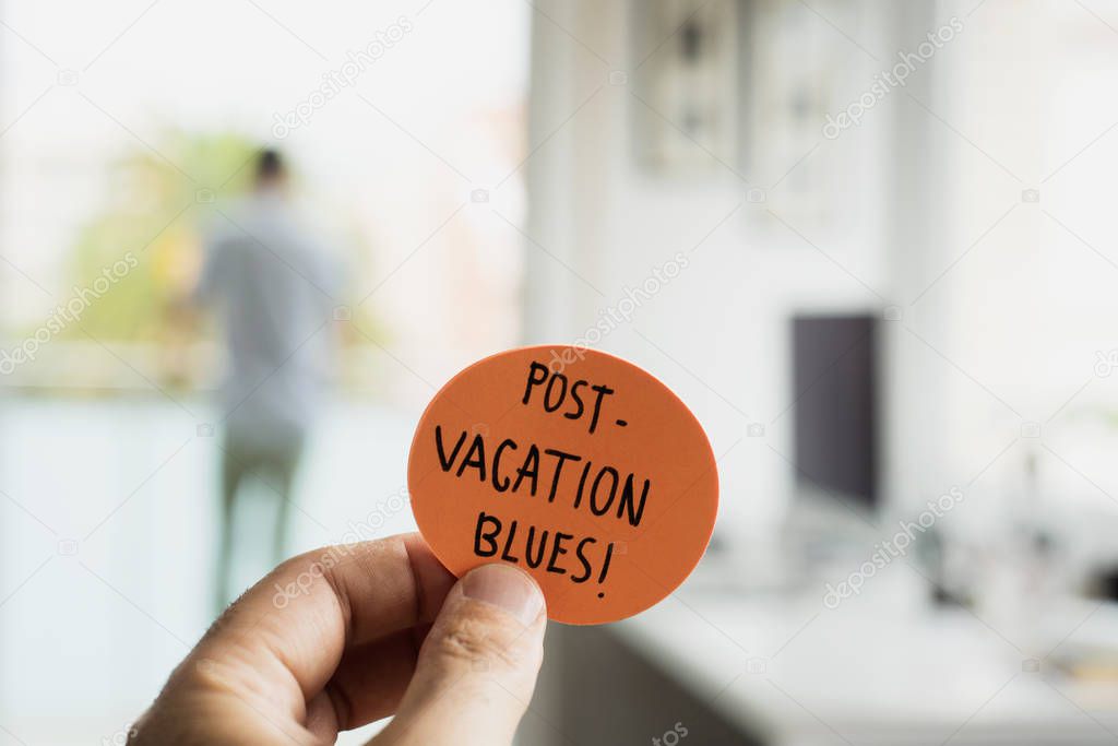 man at office and text post-vacation blues