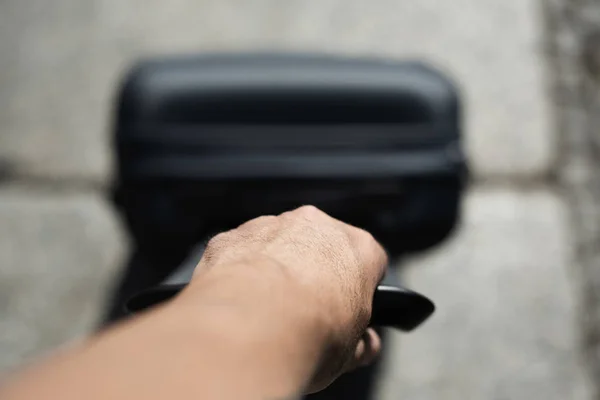 Man pulling a trolley case on the street — Stock Photo, Image