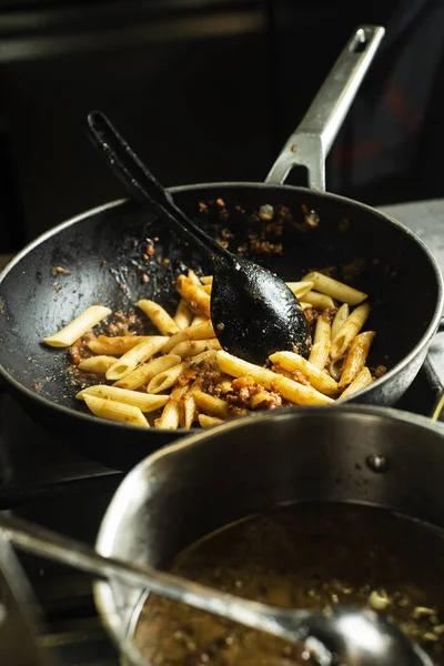 Penne rigate σε ένα τηγάνι σε μια επαγγελματική κουζίνα — Φωτογραφία Αρχείου