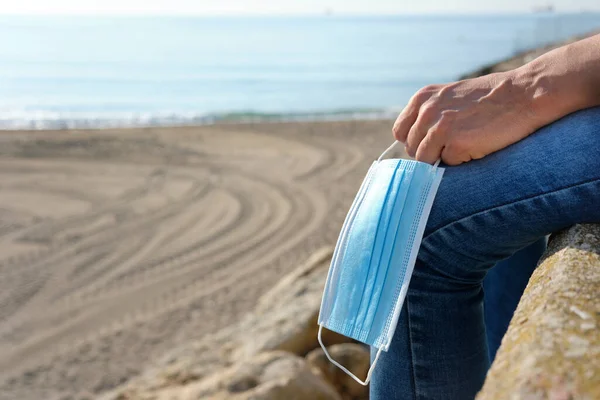 Closeup Young Caucasian Man Jeans Sitting Next Beach Holding Blue — Stock Photo, Image