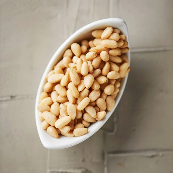 High Angle View White Ceramic Bowl Full Shelled Pine Nuts — Stock Photo, Image