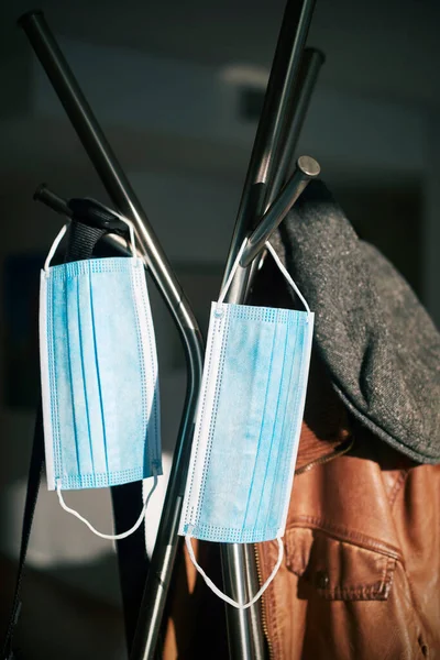 Closeup Some Blue Surgical Masks Hanging Metal Coat Stand Next — Stock Photo, Image