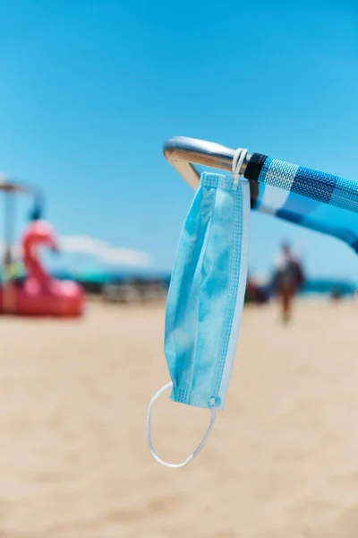 Closeup Surgical Mask Hanging Blue Deck Chair Beach Sea Background — Stock Photo, Image