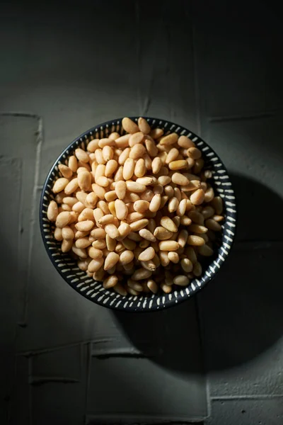 High Angle View Ceramic Bowl Full Shelled Pine Nuts Dark — Stock Photo, Image