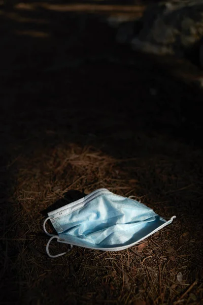 Closeup Blue Used Surgical Mask Thrown Ground Woods — Stock Photo, Image