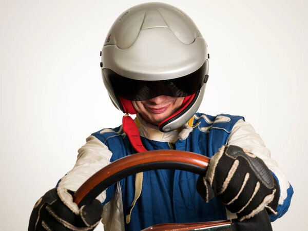 Race car driver in the helmet while driving. On a white background