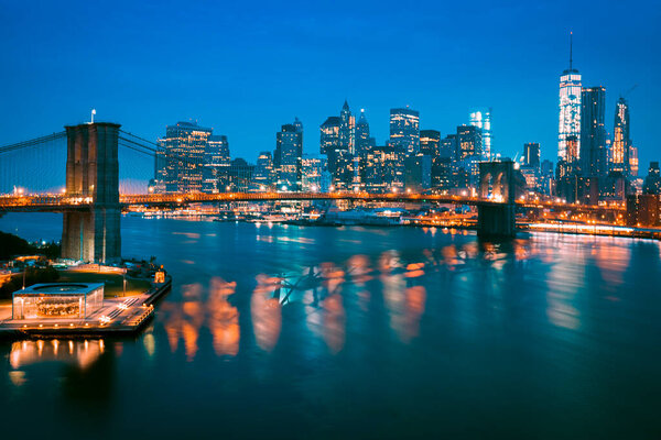 New York City Manhattan midtown at dusk with Brooklyn Bridge.