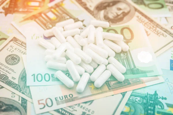 high cost of healthcare. pills and money.