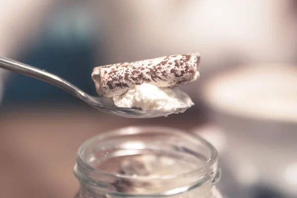sweet cream dessert on a spoon