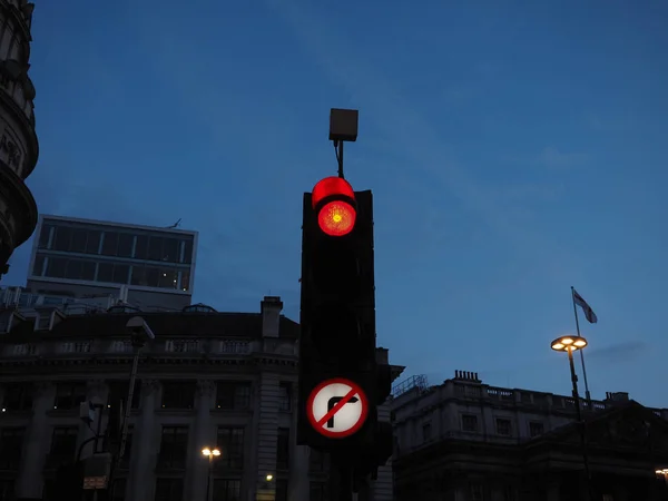 Traffic signal red light meaning stop. View at twilight blue hour before sunset