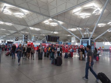 STANSTED, UK - CIRCA JUNE 2018: Travellers at London Stansted airport design by architect Lord Norman Foster clipart