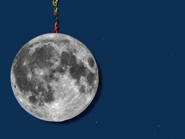 paper moon hanged with a rope over sky with stars, useful for merry christmas greeting cards