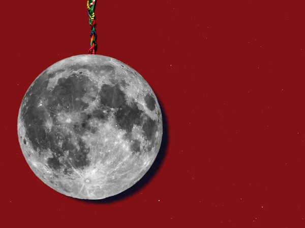 paper moon hanged with a rope over sky with stars, useful for merry christmas greeting cards