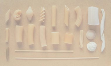 Many different types of Italian pasta including penne macaroni (maccheroni) fusilli spaghetti trenette (linguine) orecchiette tortiglioni conchiglie (shells), delicate soft faded tone useful as background clipart