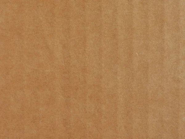 brown corrugated cardboard surface useful as a background, soft pastel colour