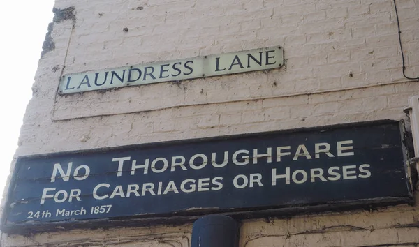 ancient no thoroughfare for carriages or horses sign in Laundress Lane in Cambridge, UK