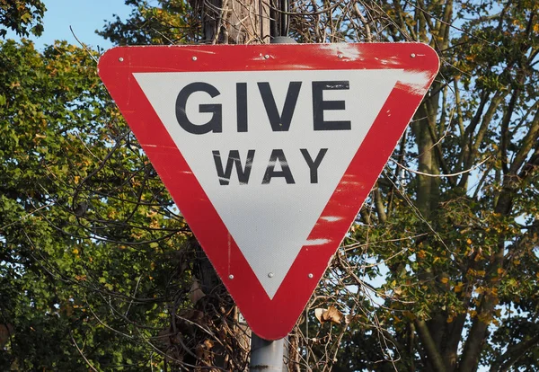 Regulatory signs, give way traffic sign over trees