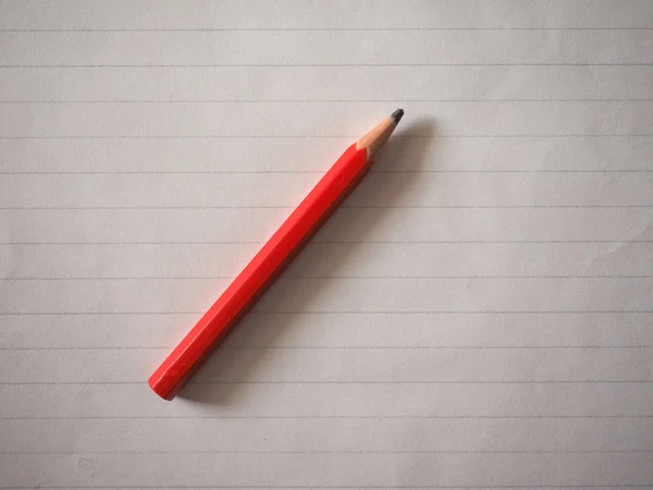 Red pencil over paper — Stock Photo, Image