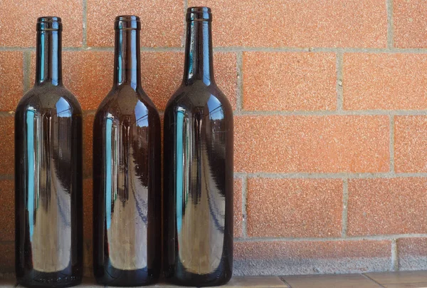 three empty wine bottles