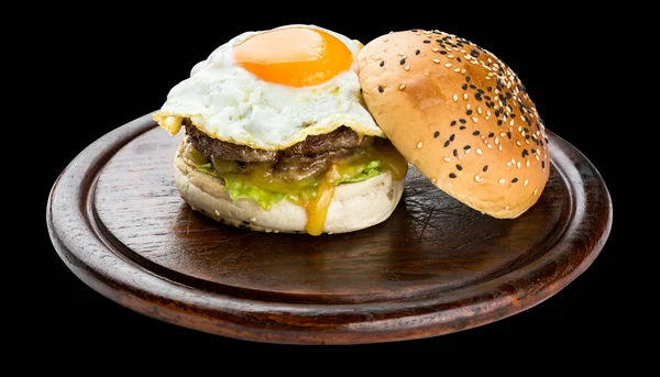 Breakfast Burger with fried egg isolated on black background