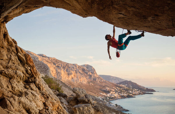 Caucasian man climbing challenging route 