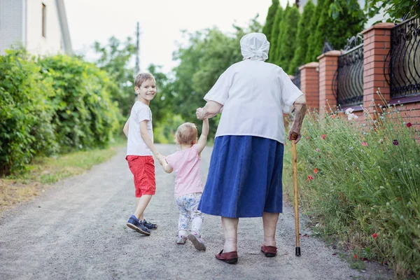 Young Boy Little Girl Great Grandmother Walking Street Countryside — Stockfoto