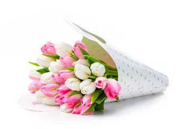 Beyaz arkaplanda kağıt torba içinde bir sürü lale.