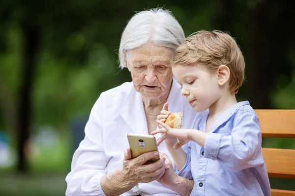 Young Boy His Great Grandmother Watching Video Smartphone Using Smartphone — Stock Photo, Image