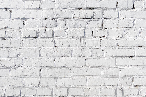 Painted brick wall. Empty light background. The texture of the brickwork.