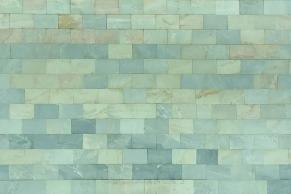The wall is made of marble blue and turquoise tiles. Beautiful stone texture. Empty background. — Stock Photo, Image