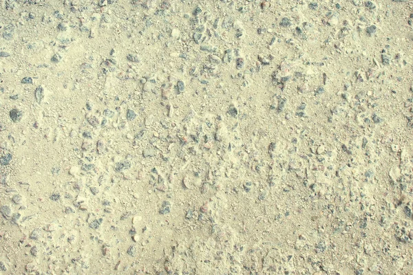 Textura de asfalto desgastado, grava se ve. Fondo vacío de la superficie del camino viejo . — Foto de Stock