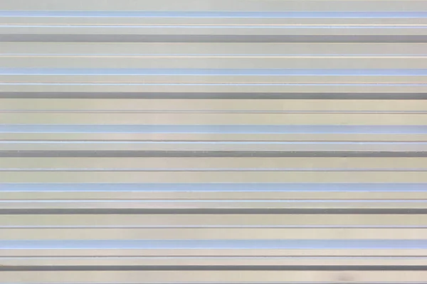 Texture of the metal corrugated fence. Background with parallel horizontal stripes of gray. — Stock Photo, Image