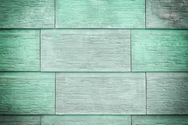 Duvar büyük yeşil ve turkuaz plakaların. Büyük tuğla, taş imitasyon. Doku, fotoğraf vignette ile.
