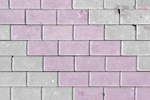 The texture of the paving slab laid out diagonally. Blank background, made of gray and pale pink bricks. — Stock Photo, Image
