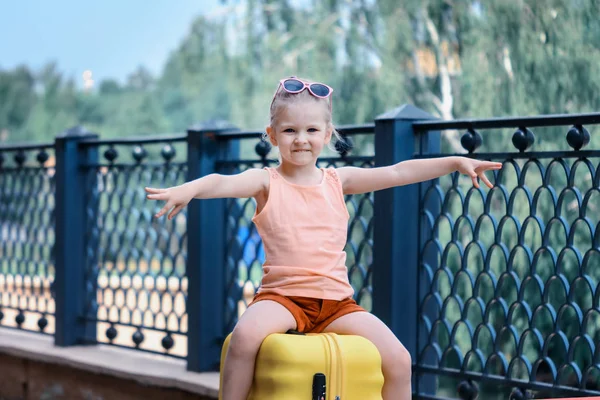 Smiling Girl Sits Large Yellow Suitcase Child Spread His Hands — Stock Photo, Image