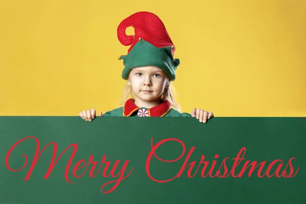 Little Girl Elf Costume Holding Green Background Inscription Merry Christmas — Stock Photo, Image