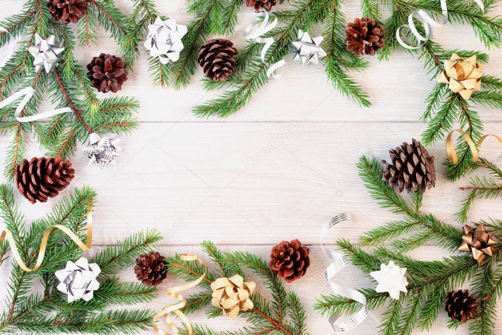 Christmas composition of fir branches decorated with bows and pine cones